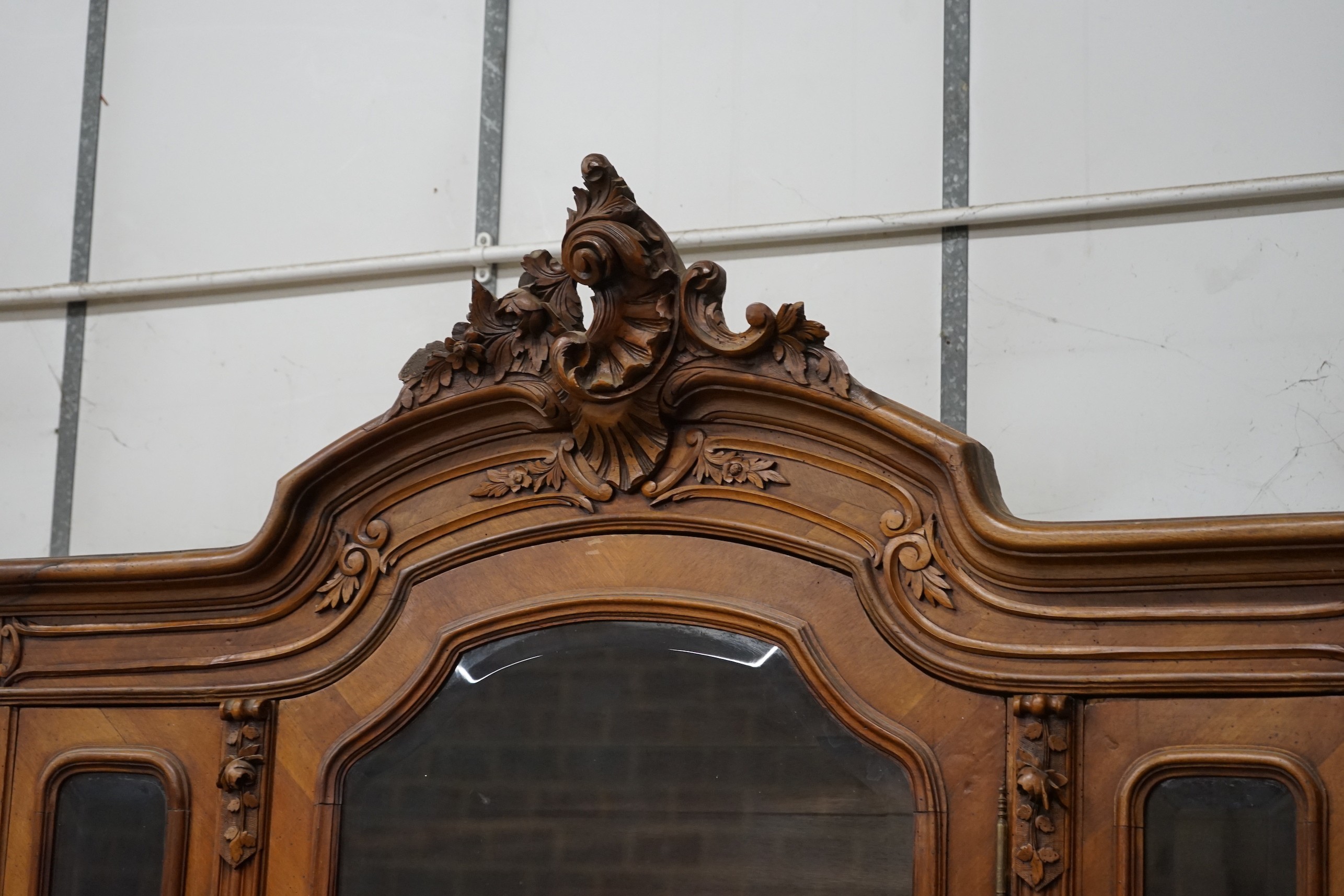 An early 20th century French glazed walnut vitrine, width 160cm, depth 48cm, height 250cm